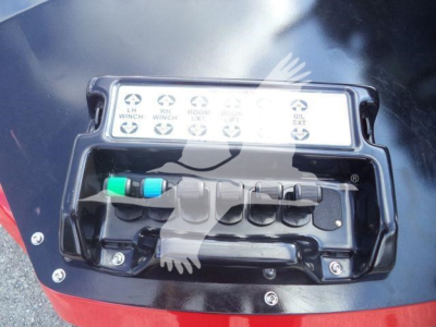 Winch controller panel on a 2025 International MV truck showing multiple labeled switches and a cable lead.