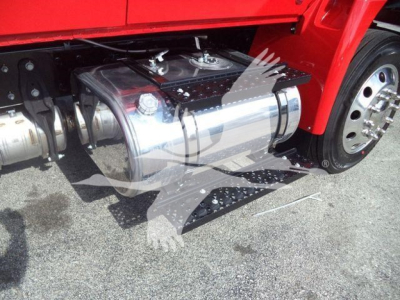 Winch-equipped truck side view showing polished rectangular fuel/equipment tank under the cab and left front wheel.