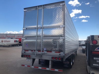 Rear/side view of a new 2026 Utility Utility 3000R refrigerated trailer with diamond plade aluminum walls, dual rear doors, and reflective safety stripes.