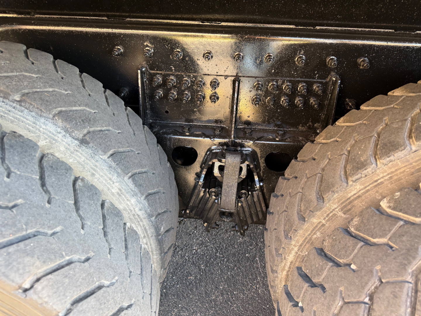 Truck chassis and dual rear axles showing heavy-duty suspension and frame; no text visible in image.