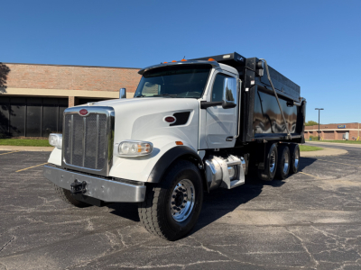 Peterbilt 567 dump truck in-service showing front grille and side view with dump bed