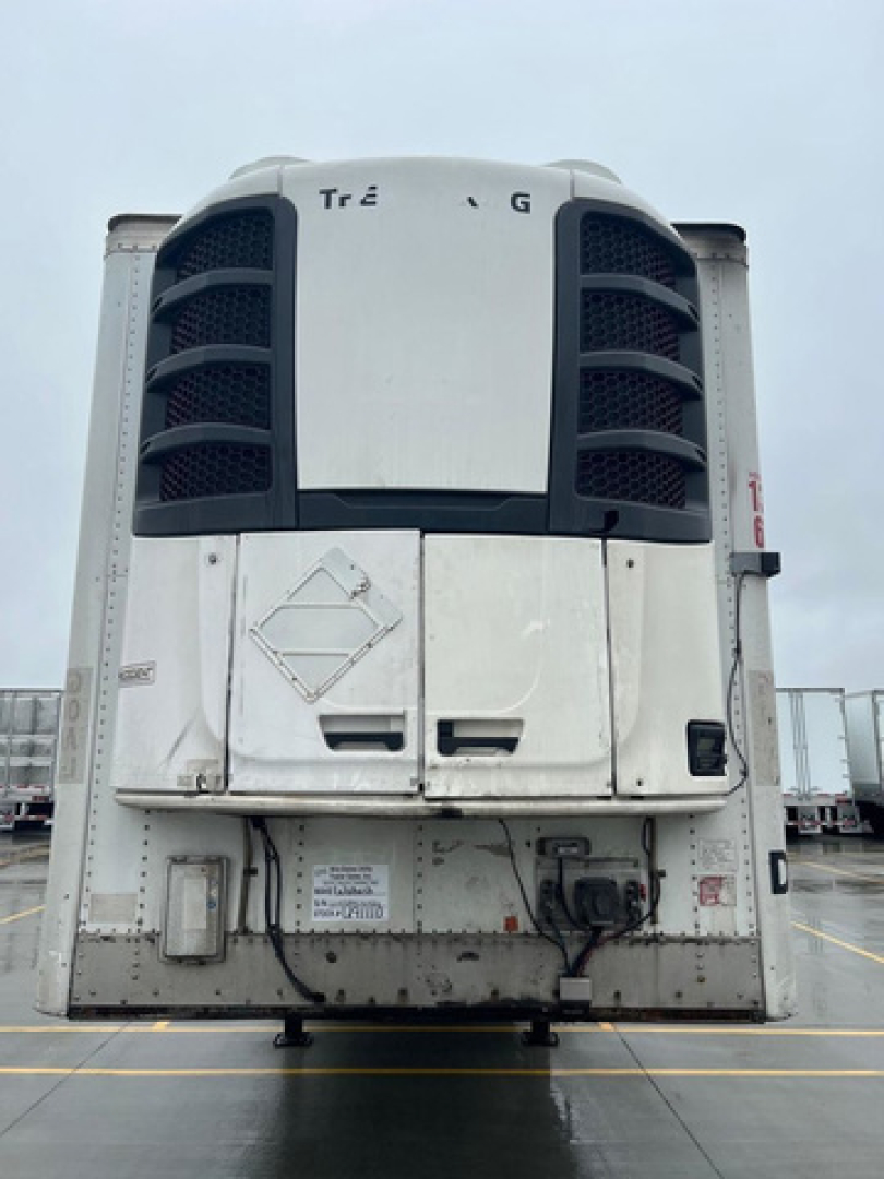 Reefer trailer at a yard showing front refrigeration unit with metal doors and control area.