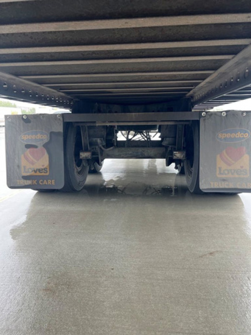Rear view of a 2014 Wabash reefer trailer showing undercarriage and twin axles with Love's Truck Care logos.