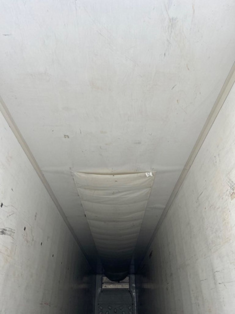 Trailer interior showing refrigerated cargo space of a 2014 Wabash reefer with white walls and ceiling, vertical side panels, and a center aisle.