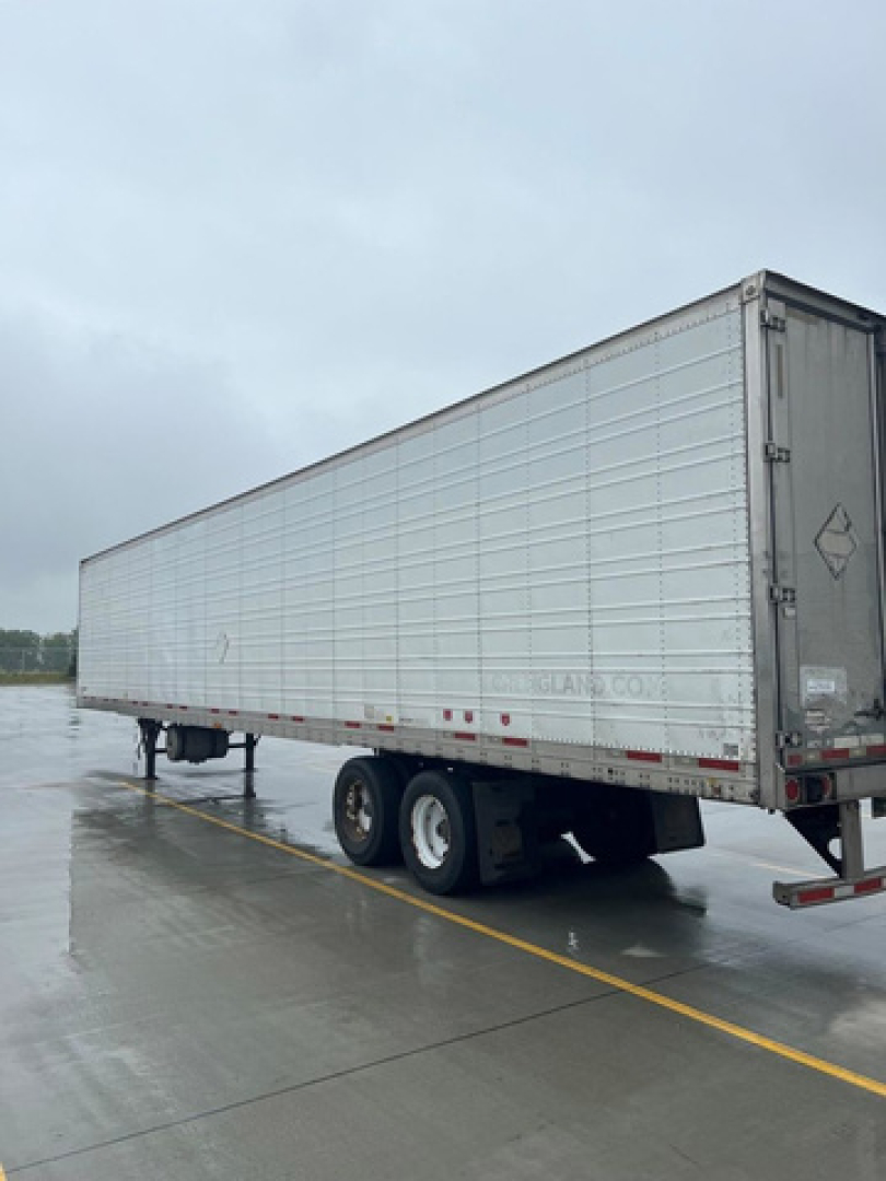 Refrigerated trailer in a parking lot showing side and rear of a 2014 Wabash refrigerated trailer.