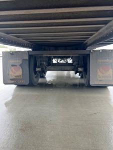 Rear view of a 2014 Wabash reefer trailer showing undercarriage and twin axles with Love's Truck Care logos.