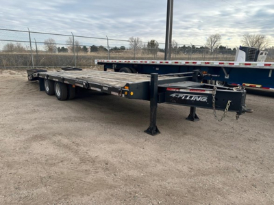 Flatbed trailer showing tandem axle and front support leg with Felling branding on the frame.