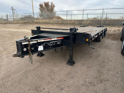 Flatbed trailer showing Felling FT-24-2 LP with black frame and low-profile support legs, rear hitch area, and chains visible.