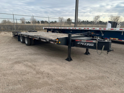 Felling Ft-24-2 LP flatbed trailer showing steel frame and dual rear axles with landing gear and chains.