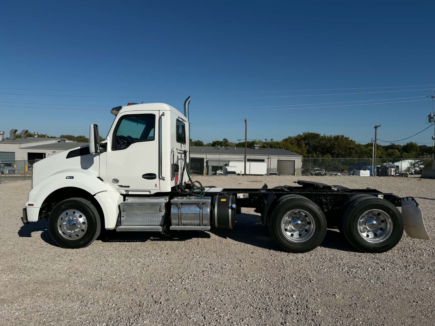 Kenworth T880 daycab chassis shown in side profile with white cab and dual rear axles.