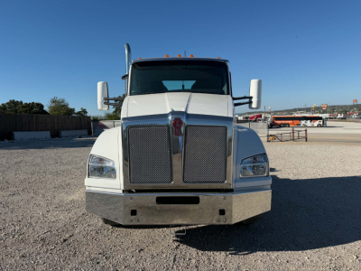 Kenworth T880 conventional daycab front view showing large chrome grille and bumper.