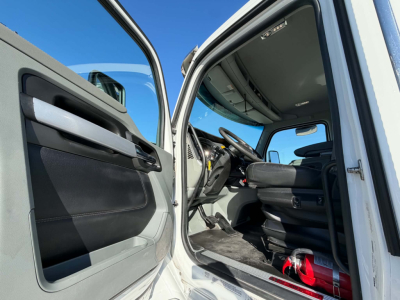 Kenworth T880 cab interior and driver seat view through open door showing steering wheel and dashboard