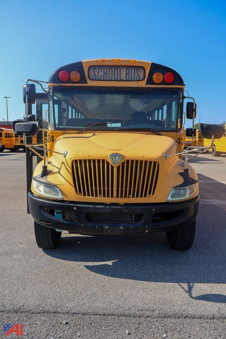School bus front view showing yellow CE Series bus with grille and 'SCHOOL BUS' sign.