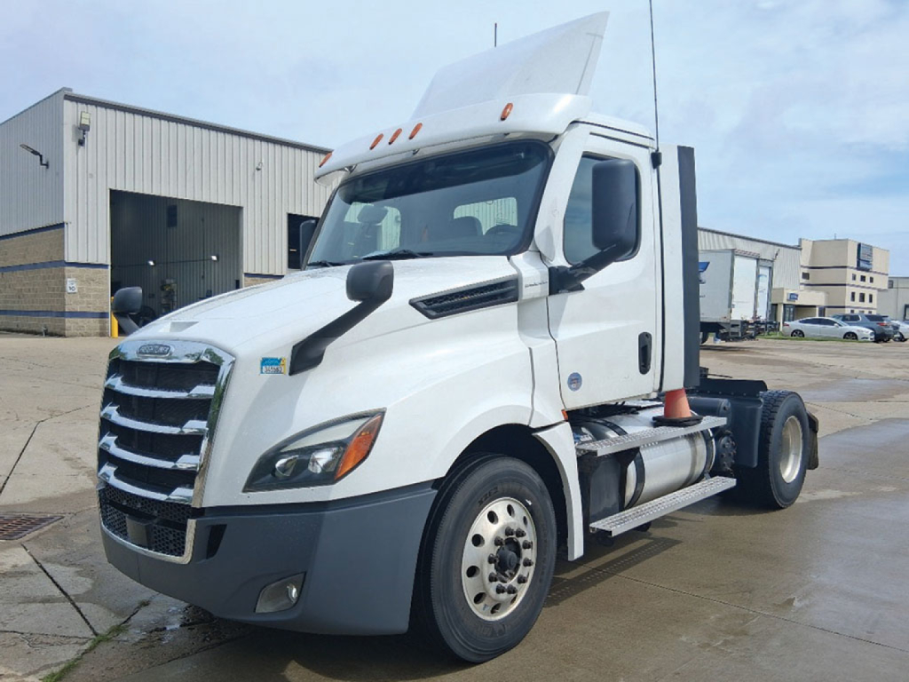Freightliner Cascadia126 daycab truck side view showing front grille, hood, and cab with white exterior.