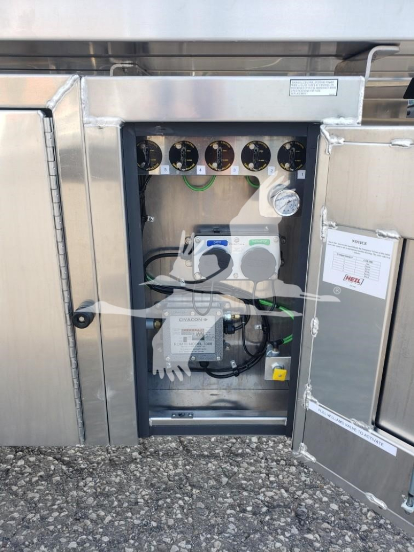 Heil 406A Petro trailer control panel with gauges and electrical components inside open access box.