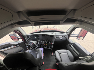 Kenworth T680 truck cabin interior showing steering wheel dashboard and controls