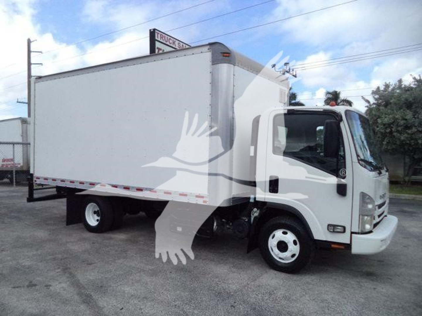 Isuzu NPR HD box truck side view showing cargo box and cab with white exterior.