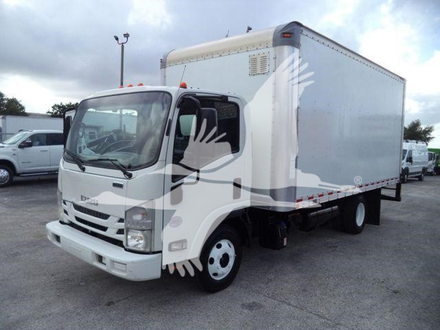 Isuzu NPR-HD box truck in view showing cab and cargo box, with stock number T11138FM on lot.