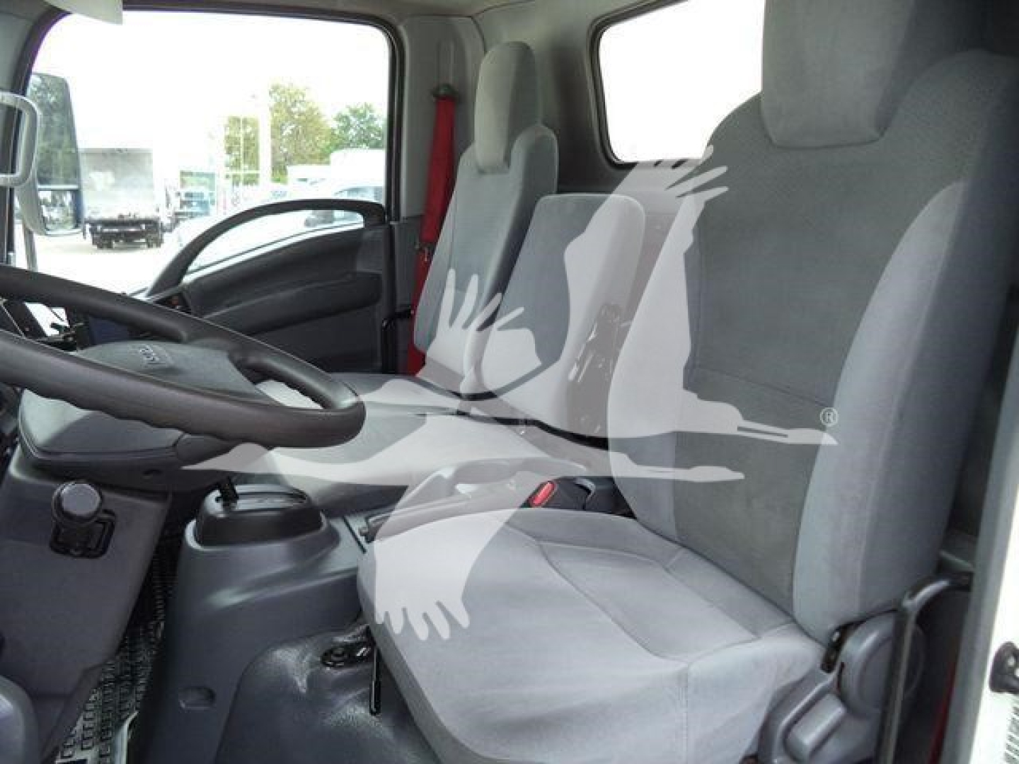 Isuzu NPR HD truck cab interior showing driver seat and passenger seat with steering wheel and dashboard