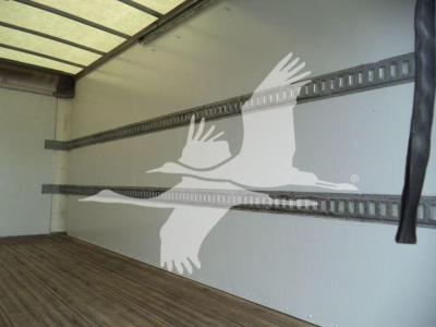 Isuzu NPR HD truck box interior showing wall and tie-down rails with a partially visible black strap.