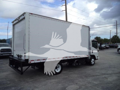 Isuzu NPR HD box truck viewed from rear-left side showing cargo box and rear bumper. Visible text not legible.