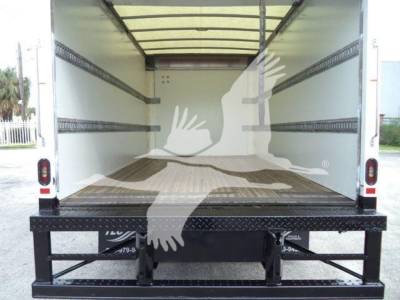 Isuzu NPR-HD box truck cargo area with empty interior and side wall rails; rear tail with ramp platform visible.