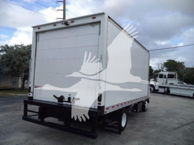 Isuzu NPR-HD box truck rear view showing plain white cargo box and black rear bumper.