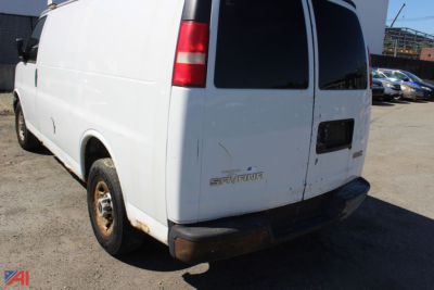 GMC Savana cargo van rear view showing tail lights and emblem