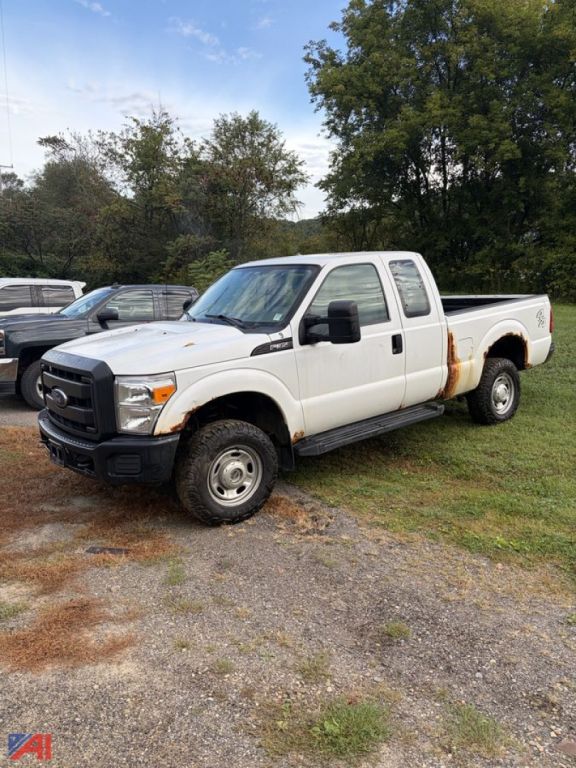 Ford F-350 Super Duty pickup truck, single rear wheel, white, side view showing extended cab with dual rear doors, black grille, grille badge, and utility bed rust stain along cab side.