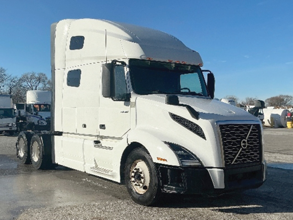 Truck cab exterior with Volvo logo on grille; front view of a white 2023 Volvo VNL 760 sleeper truck. Visible text includes 'Volvo' on grille and model styling but no legible serials or stickers.