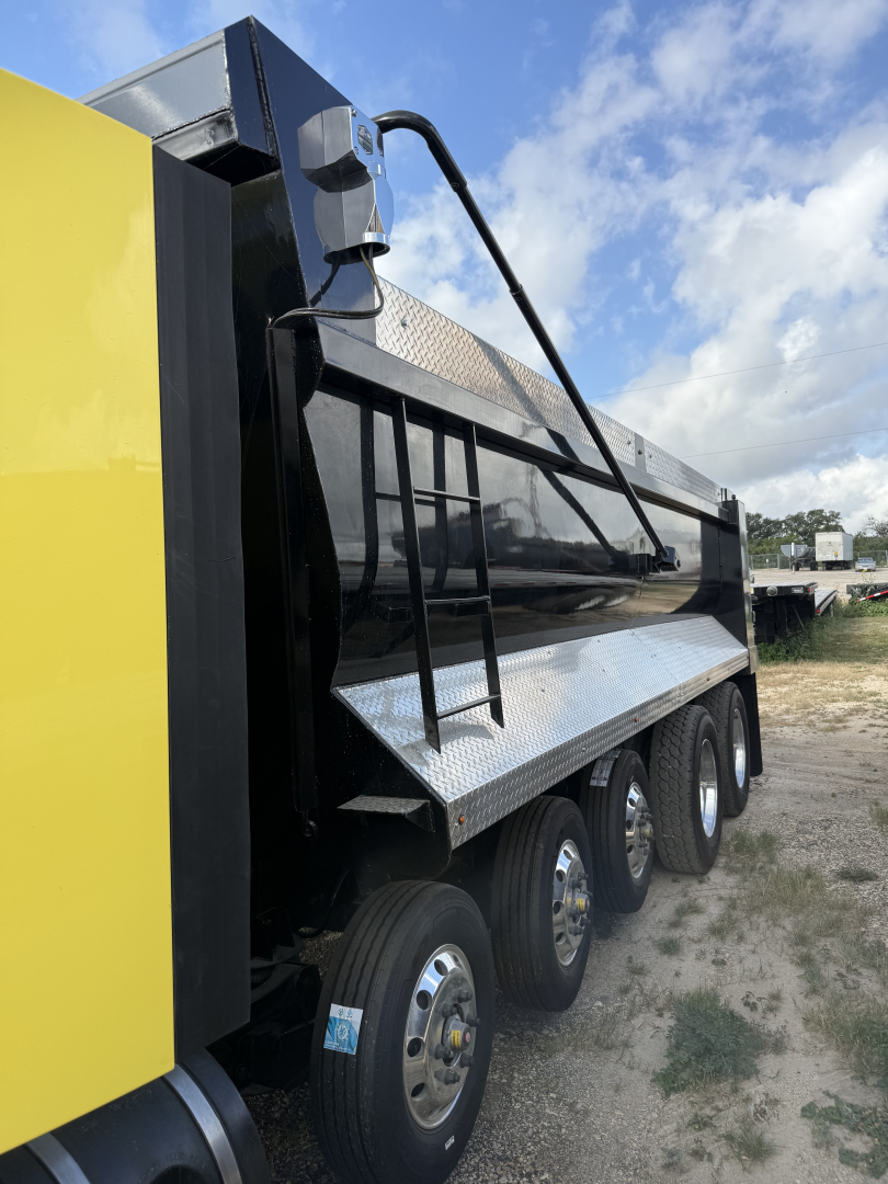 Peterbilt 579 dump truck side view showing heavy-duty dump bed with ladder and multiple axles, VIN 1XPBDP9X0HD410466 visible in listing.