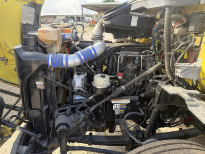 Peterbilt 579 dump truck engine bay view with exposed components, hoses, and labels visible