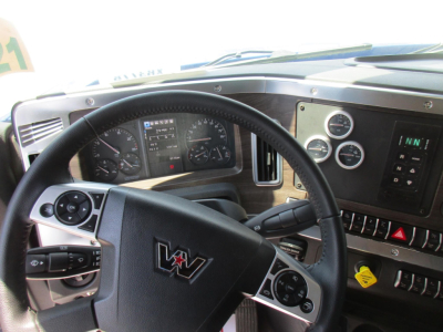 Western Star 49X cab interior showing steering wheel and instrument cluster with gauges and control panels.