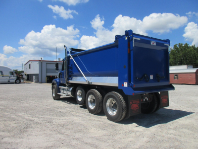 Western Star 49X dump truck in blue with rear dump bed, three-axle configuration, side view showing tires and hydraulic tipping mechanism.