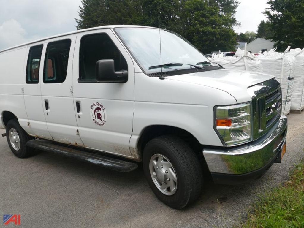 Ford E-250 cargo van side/front view showing white body, black mirrors, chrome front bumper, running boards, and a small circular logo on front door.