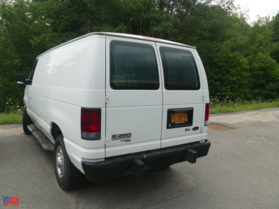 Ford E-250 cargo van rear view showing dual rear doors and NY license plate.