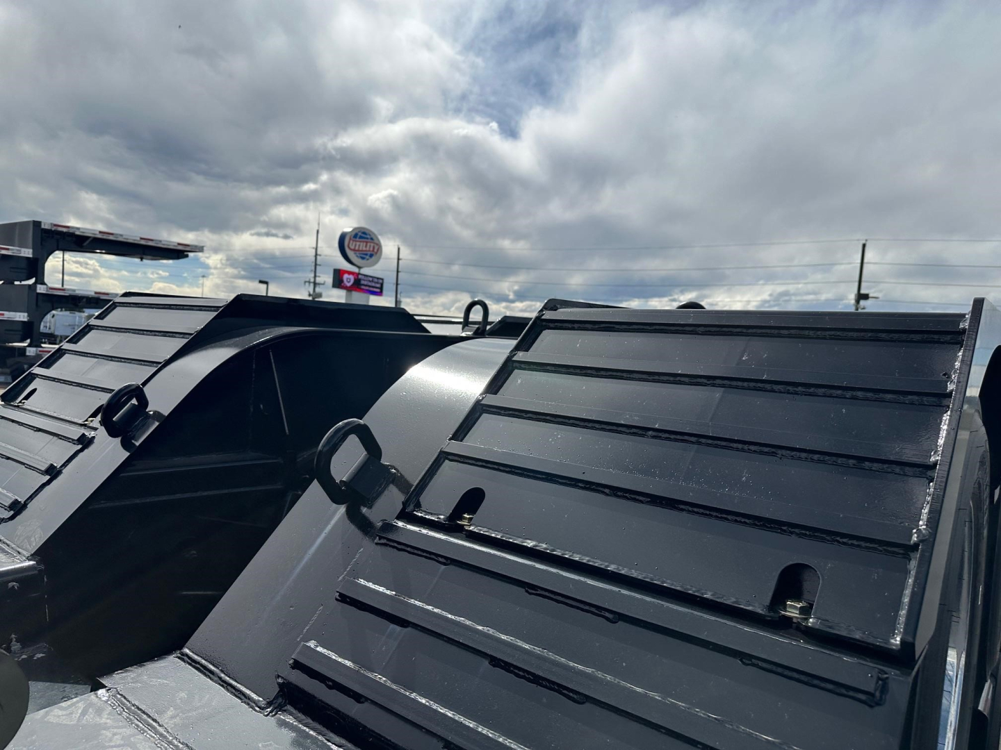 Trailer deck edges and side panels of a Load King lowboy trailer showing metal surface and welds.