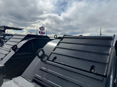 Lowboy trailer deck edge with metal lip and stake pockets.