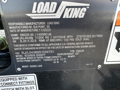Load King trailer nameplate showing manufacturer, GVWR, GAWR, tire specs and model details on black metal plate.