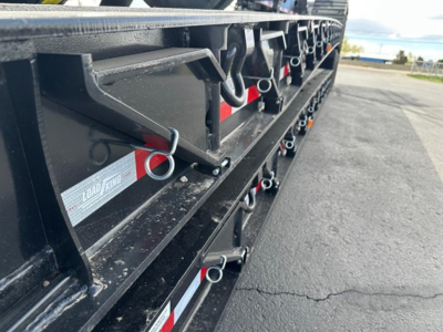 Trailer structural side showing Load King branding and attachment points with rings and latches