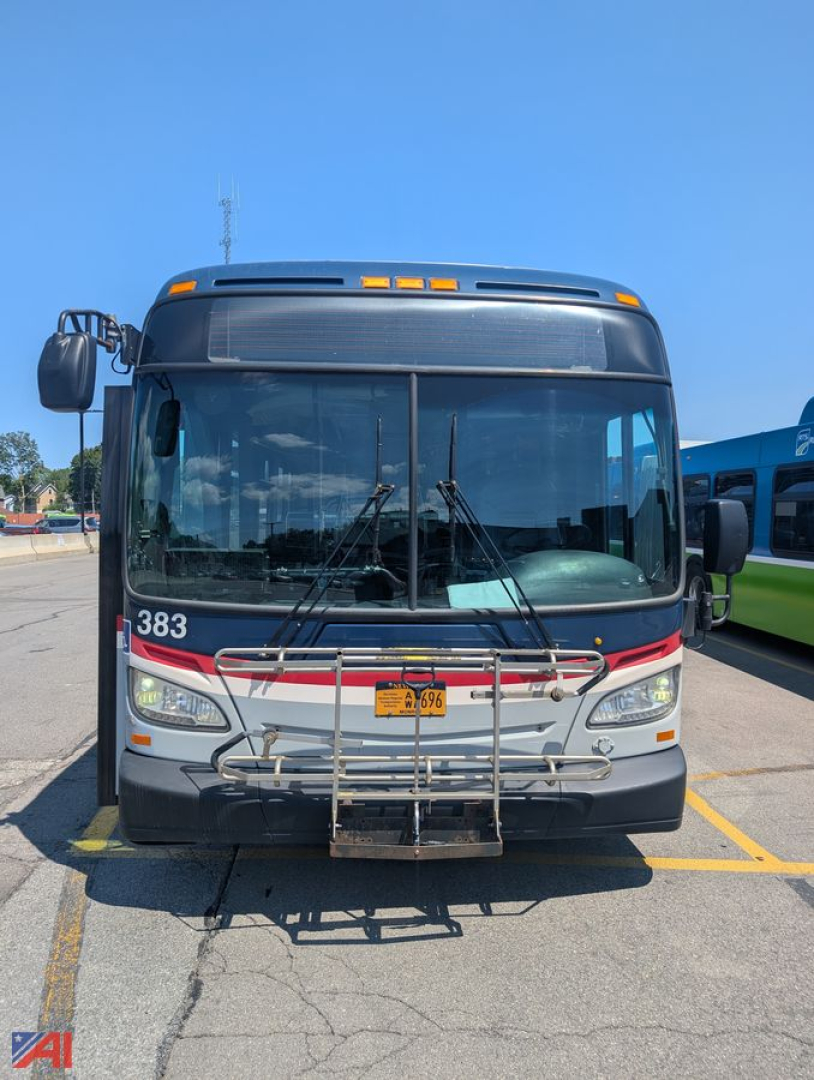 Front view of a 2013 New Flyer XD60 transit bus with a bike rack attached to the front bumper, bus number 383, large windshield, and orange clearance lights on the roof.