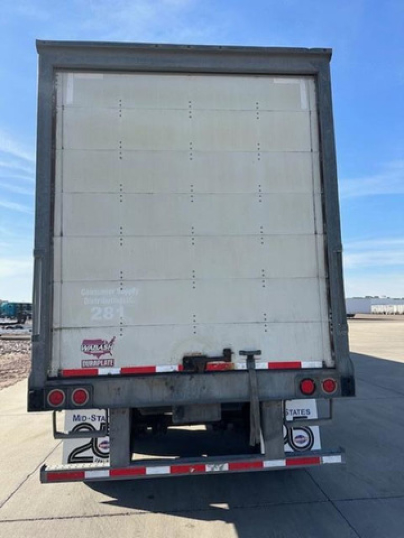 Rear view of a Wabash trailer van showing back doors and rear bumper with lights and reflectors.