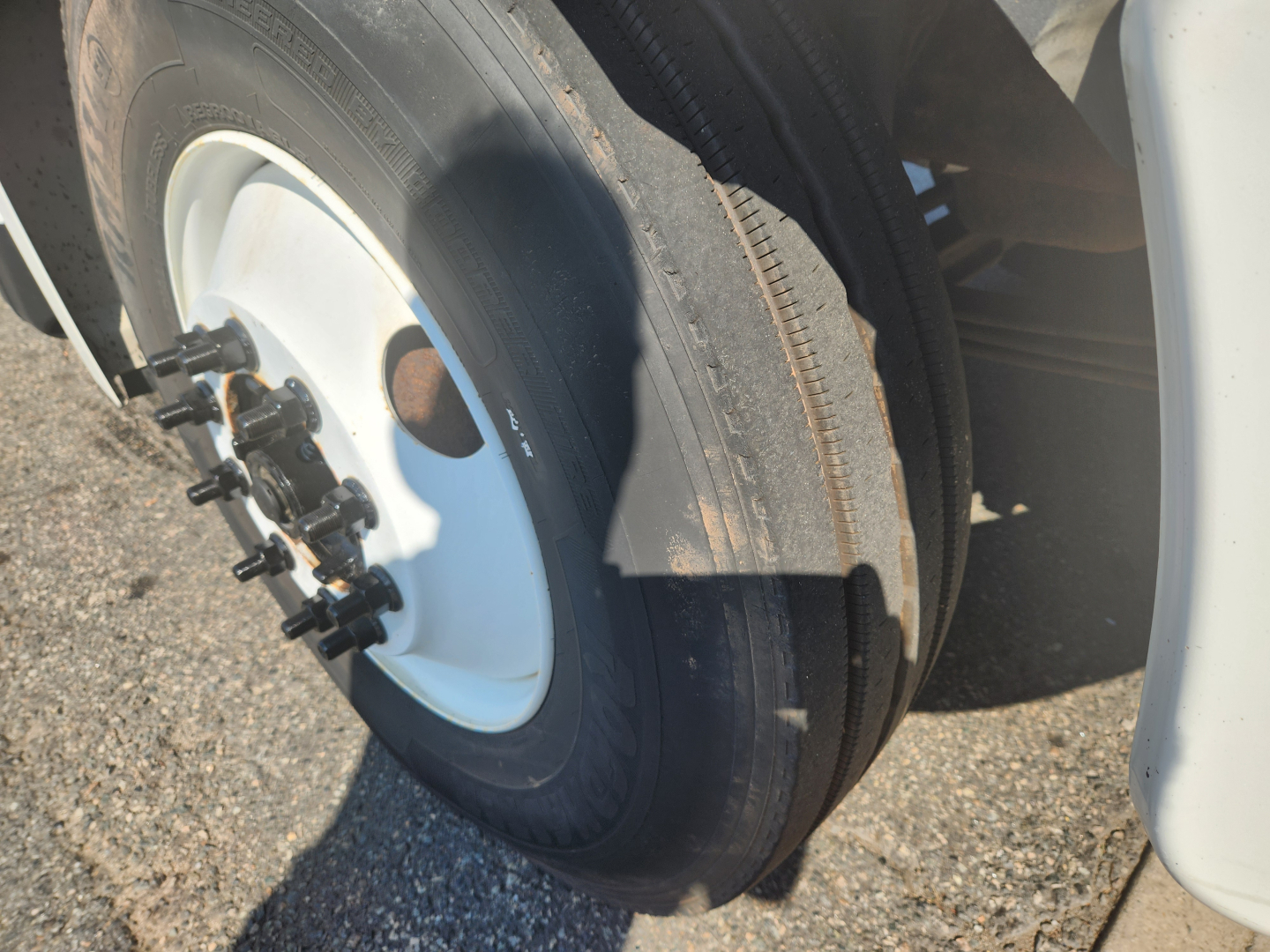 Wheel and tire of a Hino truck with hub, showing tire and wheel area.