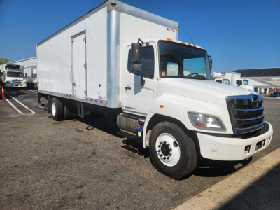 Box truck showing 2018 Hino 338 de-rate details on a used white cab chassis with large box cargo area