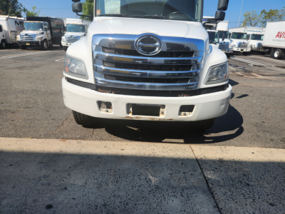 Front view of a white 2018 Hino 338 box truck showing chrome grille, headlights, and bumper. VIN and stock number not visible in image.