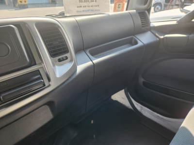 Interior of a 2018 Hino 338 cab showing dashboard, glove box, passenger door, and front passenger seat.