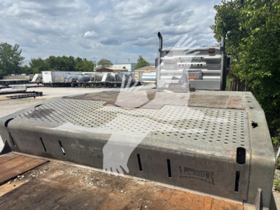 Landoll 950C trailer deck with perforated steel catwalk and metal tool storage shroud showing perforated surface and cutouts.