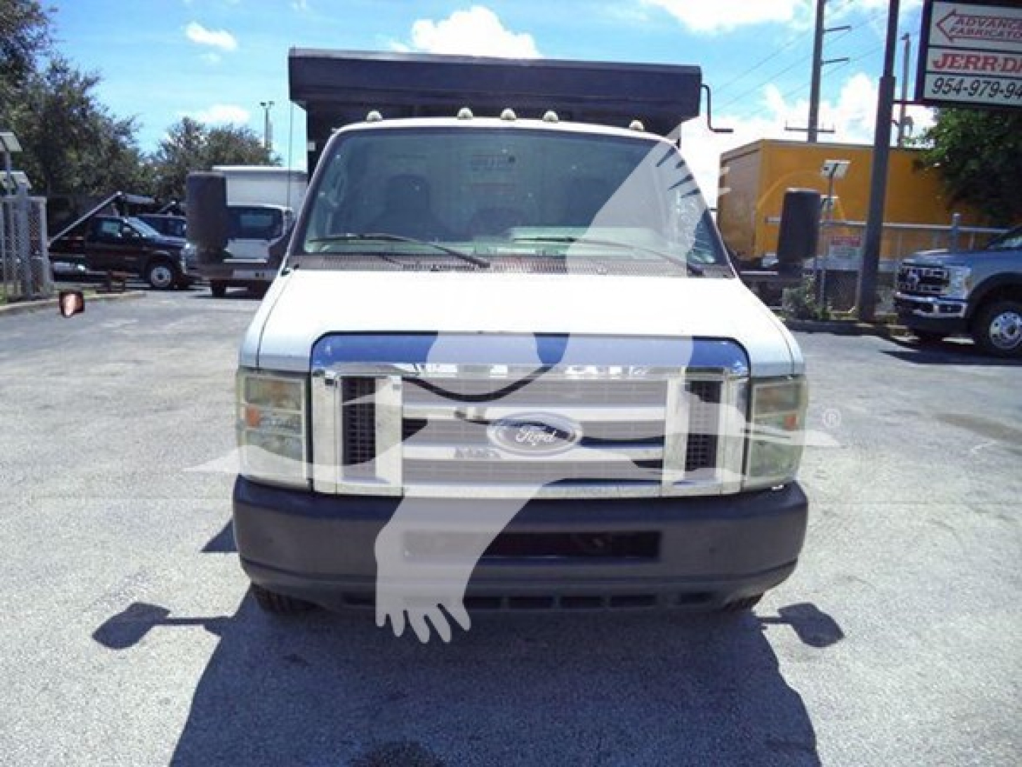 Front view of a white 2011 Ford E450 dump truck showing grille, headlights, and front bumper; stock number T96628 possibly visible
