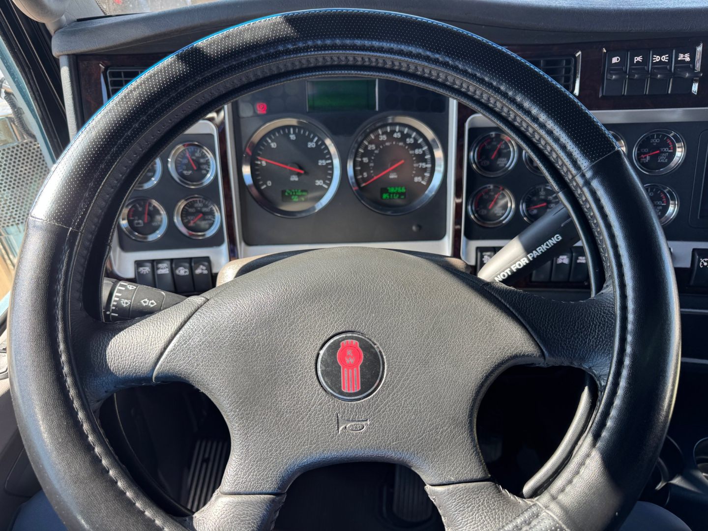 Kenworth W900L interior dashboard and steering wheel with gauges and controls visible