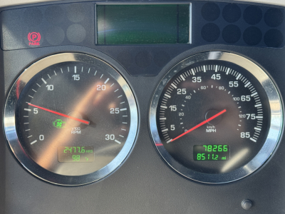 Kenworth W900L instrument cluster showing two round gauges with digital odometer/readouts.